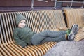 Stylish boy sitting on the bench and relax in park, fall vibes, autumn beauty style, child fashion