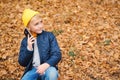 Stylish boy talking on cell phone outdoors. Kid on a walk in autumn park. People, technology and communication concept. Little boy Royalty Free Stock Photo