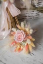 Stylish bridal bouquet of preserved flowers and lagurus with boutonniere. Dried and preserved flowers brides bouquet in