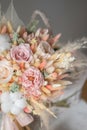 Stylish bridal bouquet of preserved flowers and lagurus with boutonniere. Dried and preserved flowers brides bouquet in