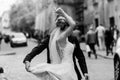 Stylish bride and groom dancing and having fun in city street. happy luxury wedding couple holding hands in light. romantic Royalty Free Stock Photo