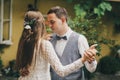 Stylish bride and groom gently dancing together in stylish restaurant among trees. Provence wedding. Beautiful romantic wedding Royalty Free Stock Photo