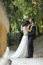 Stylish bride and groom at a park on their wedding day. Beautiful love story in nature, couple in love Royalty Free Stock Photo