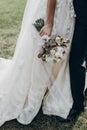 Stylish bride holding golden bouquet of roses with ribbons, stan Royalty Free Stock Photo