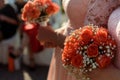 Stylish bridesmaids in pink lace dress holding amazing bouquets