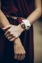 Stylish bridesmaids with red and white flowers on boutonniere on