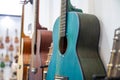 Stylish bright blue acoustic guitar close up, acoustic guitars in the row in a music shop, selective focus Royalty Free Stock Photo