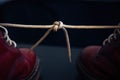 Stylish bright red shoes with thick white laces tied together, close-up, selective focus, space for text. April Fools` day, prank Royalty Free Stock Photo