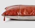 Stylish brown leather sofa pillow with linen back and side zipper Royalty Free Stock Photo