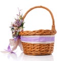 Stylish brown wicker Easter basket with very beautiful Provence decor. Decorated with many different flowers and ribbons