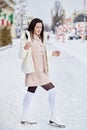 Stylish brunette girl ice skates outdoor in winter. Festive holidays mood. Dreams come true concept Royalty Free Stock Photo