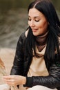 brunette girl in leather jacket and sweater with throat autumn clothes Royalty Free Stock Photo