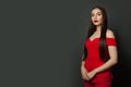 Stylish brunette woman with long healthy straight hair standing on black background Royalty Free Stock Photo