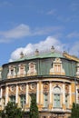 Stylish building, zinc roof, ornaments and decorations on the facade, yellow plaster color on the building, historic old building