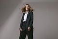 Stylish business successful confident woman in black work suit. Businesswoman in an oversized jacket looking forward