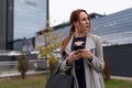 stylish business woman with a laptop in her hands on the background of an office building, concept of successful Royalty Free Stock Photo