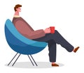 Stylish businessman sitting on armchair at home or restaurant holding a cup in hand drinking coffee