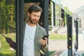 Stylish busy man getting off bus in city. Royalty Free Stock Photo