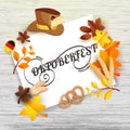 Stylish Calligraphy of Oktoberfest on white paper festival elements like pretzel, wheat ears, hat and maple leaves on white