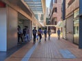 25 10 2021 stylish and cheerful male female students with face mask walk in corridor or sheltered university street paved by red