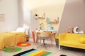 Stylish child room interior with bed and desk Royalty Free Stock Photo