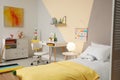 Stylish child room interior with bed and desk Royalty Free Stock Photo