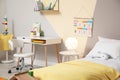 Stylish child room interior with bed and desk Royalty Free Stock Photo