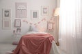 Stylish child`s room interior with pictures and comfortable bed Royalty Free Stock Photo