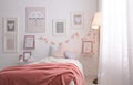 Stylish child`s room interior with beautiful pictures and comfortable bed