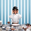 Stylish chocolate confectionery. Woman in white blouse and top hat holding chocolate biscuits on eyes. Striped, pattern