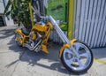 Close up of a yellow motorcycle chopper on a sidewalk