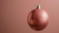 Stylish Christmas bauble with a metallic bronze snake skin texture, set against a minimalist background of muted coral