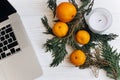 Stylish christmas flat lay. laptop and oranges and golden star a Royalty Free Stock Photo