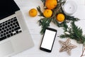 Stylish christmas flat lay. laptop and phone with empty screen o Royalty Free Stock Photo