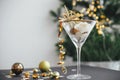 Stylish christmas glitter star in champagne glass and golden decorations on festive background with lights. New year party Royalty Free Stock Photo