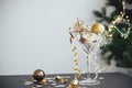 Stylish christmas glitter star in champagne glass and golden decorations on festive background with lights. New year party Royalty Free Stock Photo