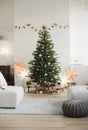 Stylish christmas interior with christmas tree, stars, gifts and decoration. Minimal xmas interior design template