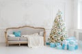 Stylish Christmas interior with an elegant sofa. Comfort home. Presents gifts underneath the tree in living room