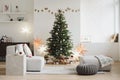 Stylish christmas interior with christmas tree, stars, gifts and decoration. Minimal xmas interior design template