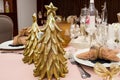 Stylish Christmas table setting, vintage cutlery, modern golden christmas trees Royalty Free Stock Photo