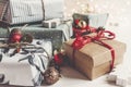 Stylish christmas wrapped presents with ornaments and lights on Royalty Free Stock Photo