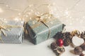 Stylish christmas wrapped presents with ornaments and lights on Royalty Free Stock Photo