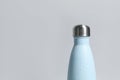 Stylish closed thermo bottle with water drops on light grey background, closeup. Space for text Royalty Free Stock Photo