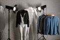 Stylish clothes on ghost mannequin and professional lighting equipment in studio. Fashion photography Royalty Free Stock Photo