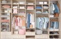 Stylish clothes, shoes and accessories in large wardrobe