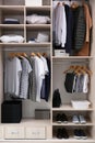 Stylish clothes, shoes and home stuff in large wardrobe Royalty Free Stock Photo