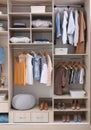 Stylish clothes, shoes and home stuff in large wardrobe Royalty Free Stock Photo