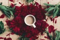 stylish coffee and beautiful red peonies on rustic wooden background flat lay. space for text. modern floral instagram blogging i