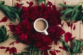 stylish coffee and beautiful red peonies on rustic wooden background flat lay. space for text. modern floral instagram blogging i