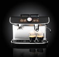 Stylish coffee machine brewing espresso in two glasses.